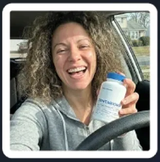 happy female customer holding DentaBiome supplement bottle inside car showing positive lifestyle use